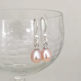 Pearl earrings with small freshwater natural pink oval pearl drops on silver hooks Pearl earrings with small freshwater natural pink oval pearl drops on silver hooks